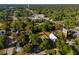 Expansive aerial view of the property nestled amongst lush greenery in a charming neighborhood with trees at 721 Ne 2Nd St, Ocala, FL 34470