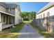 A view between buildings showcasing a peaceful backyard area, highlighting privacy and outdoor potential at 721 Ne 2Nd St, Ocala, FL 34470
