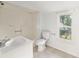 Bathroom featuring a vanity, toilet, tub with shower, and window for natural light at 721 Ne 2Nd St, Ocala, FL 34470
