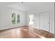 Bright bedroom with hardwood floors, white walls and trim, and large picture window at 721 Ne 2Nd St, Ocala, FL 34470