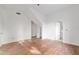 Bright bedroom with hardwood floors, white walls, trim, and vaulted ceiling at 721 Ne 2Nd St, Ocala, FL 34470