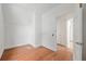 Bedroom featuring hardwood floors, white walls, and doorways to other rooms at 721 Ne 2Nd St, Ocala, FL 34470