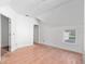 Bright bedroom featuring hardwood floors, a window, and a connecting door at 721 Ne 2Nd St, Ocala, FL 34470