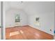 Bedroom featuring hardwood floors, a glass door, and a casement window at 721 Ne 2Nd St, Ocala, FL 34470