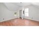 A bedroom featuring wood floors, white walls and trim, and a double-casement window at 721 Ne 2Nd St, Ocala, FL 34470