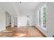 Bright bedroom features hardwood floors, white walls and trim, and large windows at 721 Ne 2Nd St, Ocala, FL 34470