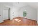 Bedroom with wood floors, white walls, window and exterior door with window at 721 Ne 2Nd St, Ocala, FL 34470