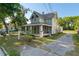 Charming two-story home featuring a cozy covered porch and mature landscaping providing a serene outdoor space at 721 Ne 2Nd St, Ocala, FL 34470
