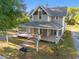Charming two-story home with a welcoming front porch and lush landscaping at 721 Ne 2Nd St, Ocala, FL 34470