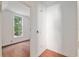 Hallway looking into a bedroom with wood floors and a large window at 721 Ne 2Nd St, Ocala, FL 34470