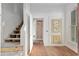 Bright room with hardwood floors, open staircase, natural light and exposed brick in the background at 721 Ne 2Nd St, Ocala, FL 34470