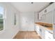 Sun-filled kitchen offers white cabinets, stainless sink and butcher block countertops at 721 Ne 2Nd St, Ocala, FL 34470