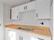 Kitchen features new cabinets and butcher block countertop at 721 Ne 2Nd St, Ocala, FL 34470