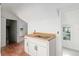 A kitchenette featuring white cabinets, stainless steel sink, and butcher block countertop at 721 Ne 2Nd St, Ocala, FL 34470