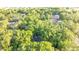 Aerial view of a home in a neighborhood, surrounded by lush trees and a natural landscape at 7585 Sw 79Th Pl, Ocala, FL 34476