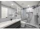 Bathroom features a modern vanity, toilet, and walk-in shower with gray and white tiling at 7585 Sw 79Th Pl, Ocala, FL 34476