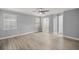 Large bedroom with wood-look floors, neutral paint, walk-in closet, and windows letting in plenty of natural light at 7585 Sw 79Th Pl, Ocala, FL 34476