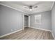 Bedroom with wood-look flooring, closet, ceiling fan and a window with natural light at 7585 Sw 79Th Pl, Ocala, FL 34476