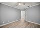 Spacious bedroom featuring wood-look floors, neutral paint, ceiling fan, and a walk in closet at 7585 Sw 79Th Pl, Ocala, FL 34476