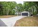 Inviting single-story home featuring a long driveway and a manicured front yard, providing a warm welcome at 7585 Sw 79Th Pl, Ocala, FL 34476