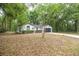 Charming single-story home featuring a well-maintained front yard and attached two-car garage in a wooded setting at 7585 Sw 79Th Pl, Ocala, FL 34476