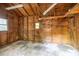 Spacious garage with concrete floor and wood paneled walls, offering ample storage and workspace at 7585 Sw 79Th Pl, Ocala, FL 34476