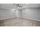 Bright living room features gray walls, wood-look floors, ceiling fan and ample natural light at 7585 Sw 79Th Pl, Ocala, FL 34476