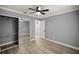 Spacious main bedroom with closet, mirror, ceiling fan, and light gray walls at 7585 Sw 79Th Pl, Ocala, FL 34476