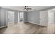 Spacious main bedroom showcasing wood-look flooring, neutral paint, and multiple closet options at 7585 Sw 79Th Pl, Ocala, FL 34476