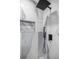 Close up of walk-in shower featuring modern shower head, hand sprayer, and built in niche at 7585 Sw 79Th Pl, Ocala, FL 34476