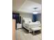 Elegant bedroom with a white bed, soft lighting, and stylish furnishings for a peaceful retreat at 807 Glen Creek Ct, Fruitland Park, FL 34731