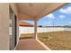 Covered patio overlooking a spacious, fenced backyard with a well-maintained lawn at 8127 Sw 60Th Ct, Ocala, FL 34476