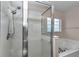 Updated bathroom with tiled shower featuring glass door and a soaking tub at 8127 Sw 60Th Ct, Ocala, FL 34476