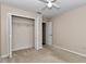 Bedroom featuring carpet, a closet with bi-fold doors, and a ceiling fan at 8127 Sw 60Th Ct, Ocala, FL 34476