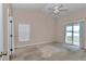 Bright bedroom with ceiling fan, large sliding doors and neutral carpet at 8127 Sw 60Th Ct, Ocala, FL 34476