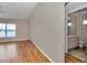 Bright primary bedroom features hardwood floors, a large window, and an en-suite bathroom at 8127 Sw 60Th Ct, Ocala, FL 34476
