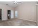 Neutral bedroom featuring a ceiling fan and doorways to the bathroom at 8127 Sw 60Th Ct, Ocala, FL 34476