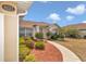 Inviting single-story home features tidy landscaping, neutral tones, and an arched entryway at 8127 Sw 60Th Ct, Ocala, FL 34476