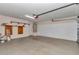 A spacious two car garage with light walls, shelving and a garage door at 8127 Sw 60Th Ct, Ocala, FL 34476