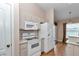 Functional kitchen with white appliances, lots of cabinet space and view to the eating nook at 8127 Sw 60Th Ct, Ocala, FL 34476