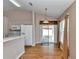 Bright kitchen features white appliances, breakfast bar, and sliding glass doors to the backyard at 8127 Sw 60Th Ct, Ocala, FL 34476