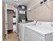 Bright laundry room featuring a washer, dryer and overhead shelving at 8127 Sw 60Th Ct, Ocala, FL 34476