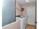 Laundry room features washer, dryer, shelving and entry door at 8127 Sw 60Th Ct, Ocala, FL 34476