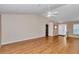 Neutral living room with hardwood floors, white door, and plenty of natural light at 8127 Sw 60Th Ct, Ocala, FL 34476