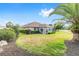 Well-maintained backyard featuring a lush lawn, mature landscaping, and a sunroom, perfect for outdoor enjoyment at 8632 Sw 86Th Cir, Ocala, FL 34481