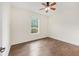 Bedroom featuring a ceiling fan, window and wood-look tiled floor at 8632 Sw 86Th Cir, Ocala, FL 34481