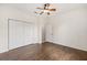 Bedroom featuring a ceiling fan, closet and wood-look tiled floor at 8632 Sw 86Th Cir, Ocala, FL 34481