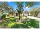 Landscaped front of a single-story home with a well-maintained lawn, plants, and a brick driveway at 8632 Sw 86Th Cir, Ocala, FL 34481