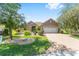 Well-maintained single-story home with lush landscaping, a brick driveway, and a two-car garage, offering comfortable living at 8632 Sw 86Th Cir, Ocala, FL 34481