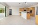 Bright, open kitchen featuring wood cabinetry, stainless steel appliances, and an island with granite countertops at 8632 Sw 86Th Cir, Ocala, FL 34481